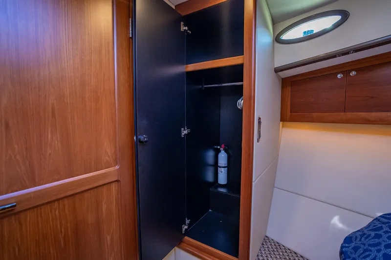 Slide: The Image of Interior of 2017 Palm Beach Motor Yachts PB45, featuring a wooden cabinet and fire extinguisher. - 41