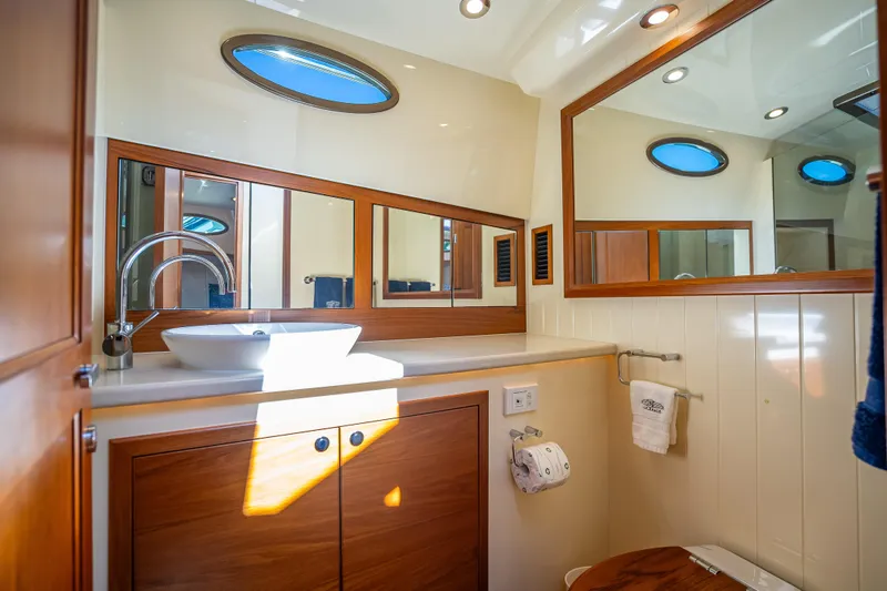 Slide: The Image of Luxurious bathroom in 2017 Palm Beach Motor Yachts PB45, featuring elegant wood cabinetry and modern fixtures. - 42