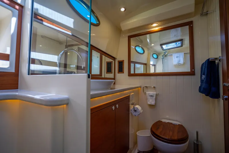 Slide: The Image of Luxurious bathroom in 2017 Palm Beach Motor Yachts PB45, featuring elegant wood accents and modern fixtures. - 43
