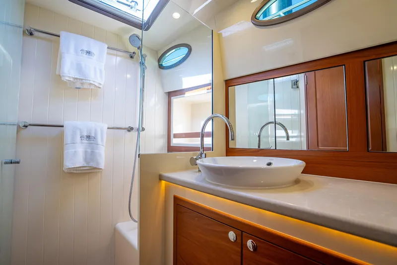Slide: The Image of Luxurious bathroom in 2017 Palm Beach Motor Yachts PB45, featuring elegant fixtures and wood accents. - 45