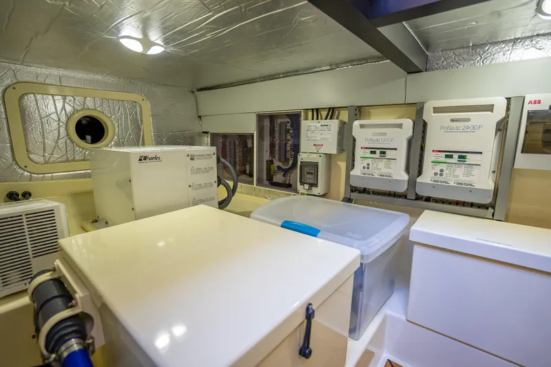 Slide: The Image of Engine room of 2017 Palm Beach Motor Yachts PB45, featuring electrical systems and equipment. - 54