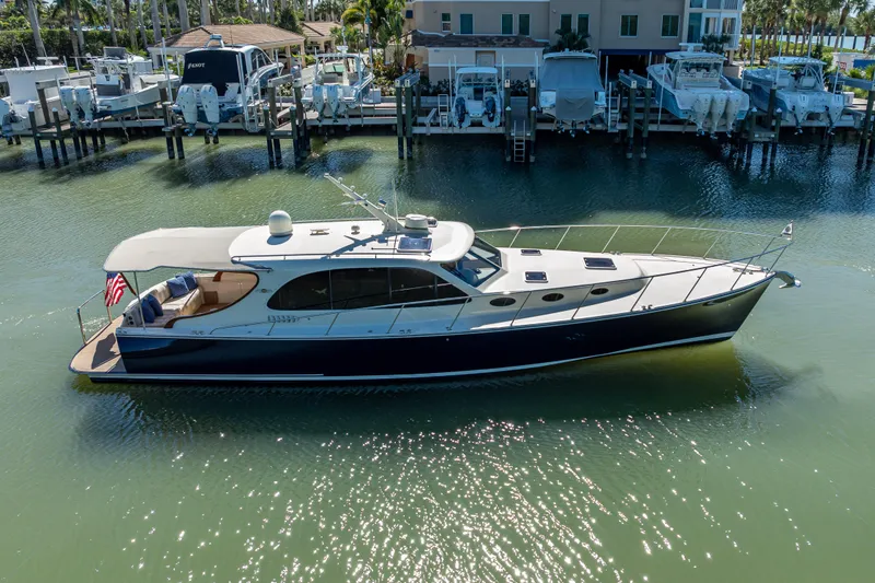 Slide: The Image of 2017 Palm Beach Motor Yachts PB45 cruising in a marina, elegant design and sleek profile. - 56