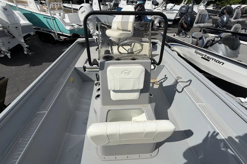 Slide: The Image of 2026 G3 Bay 20 boat dashboard with steering wheel and controls, parked outdoors. - 6