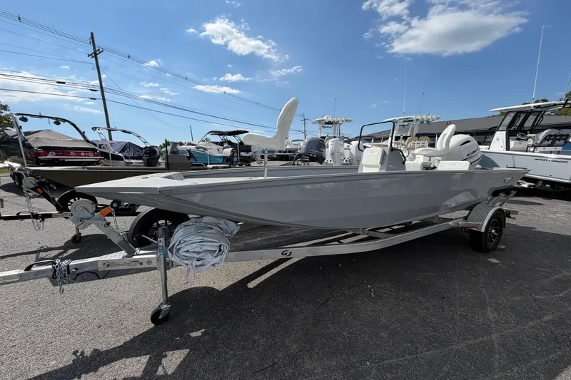 Slide: The Image of 2026 G3 Bay 20 boat interior with white seating and Yamaha motor in a showroom. - 7