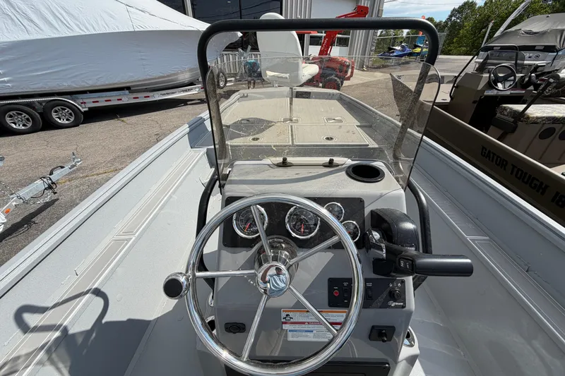 Slide: The Image of 2026 G3 Bay 20 boat with Yamaha outboard motor, parked outdoors under a clear sky. - 8