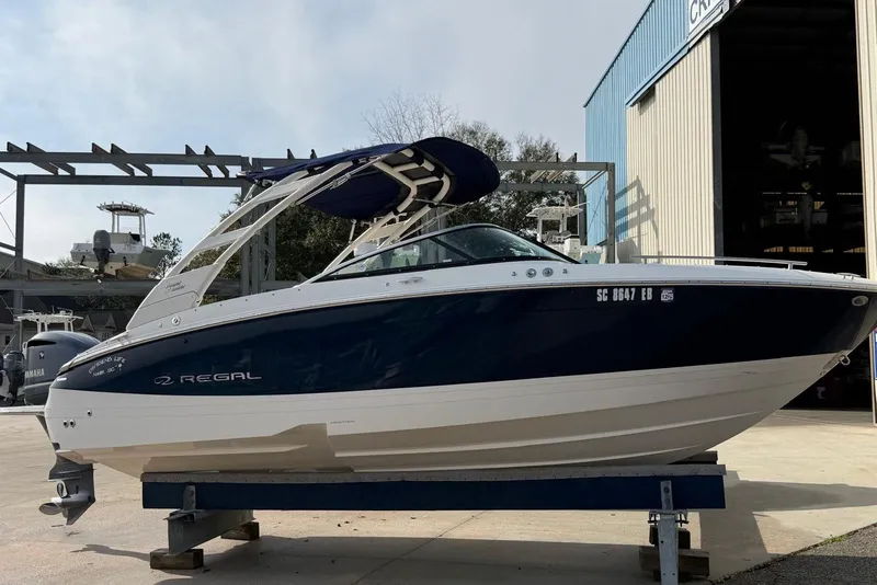 The Image of 2023 Regal LX4 boat on display at a marina, side view. - 0