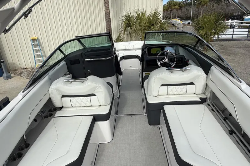 Slide: The Image of 2023 Regal LX4 boat interior with white seating and modern dashboard. - 11
