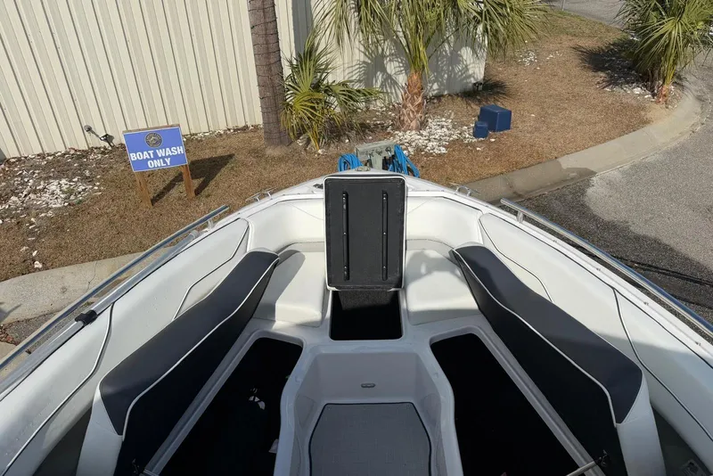 Slide: The Image of 2023 Regal LX4 boat interior at designated wash area with palm trees. - 13