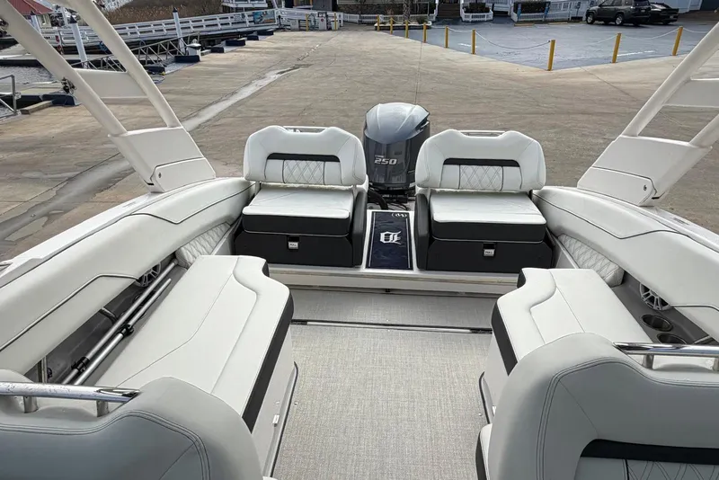 Slide: The Image of 2023 Regal LX4 boat interior with white seating and Yamaha 250 engine. - 15