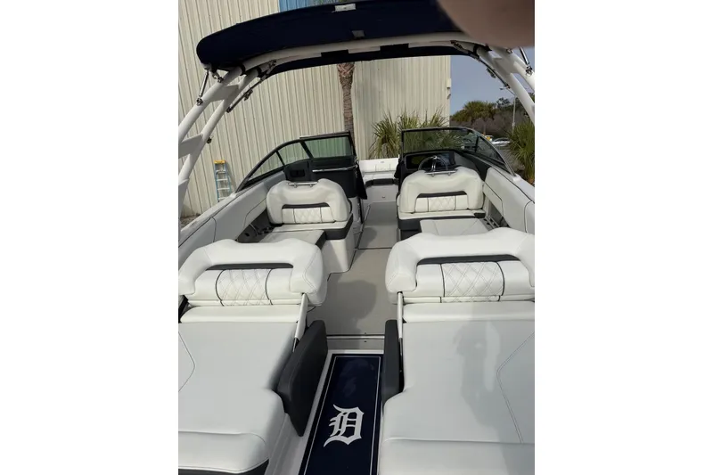 Slide: The Image of 2023 Regal LX4 boat interior with white seating and sleek design. - 17
