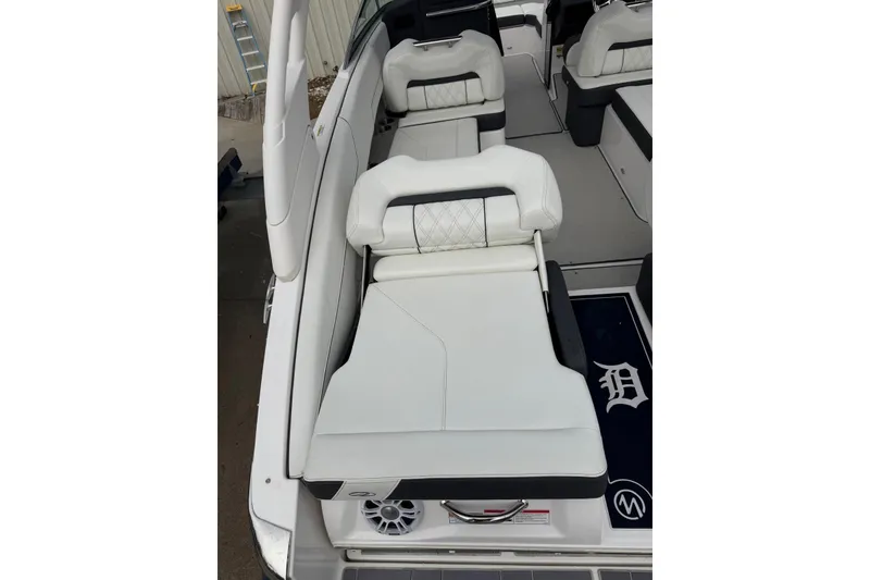 Slide: The Image of 2023 Regal LX4 boat interior with white cushioned seating and speaker detail. - 18