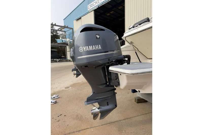 Slide: The Image of 2023 Regal LX4 with Yamaha outboard motor at a boatyard. - 19