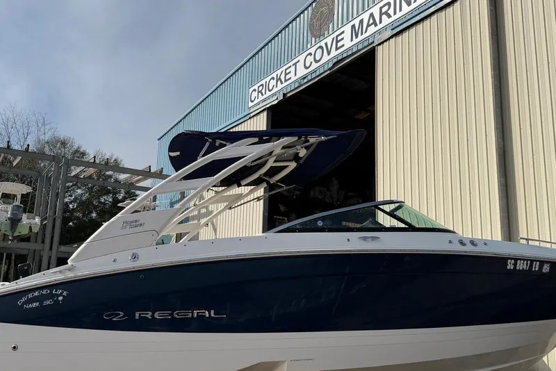 Slide: The Image of 2023 Regal LX4 boat at Cricket Cove Marina entrance. - 2
