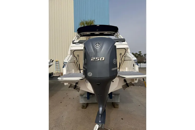 Slide: The Image of 2023 Regal LX4 boat with 250 horsepower outboard motor, docked outdoors. - 20