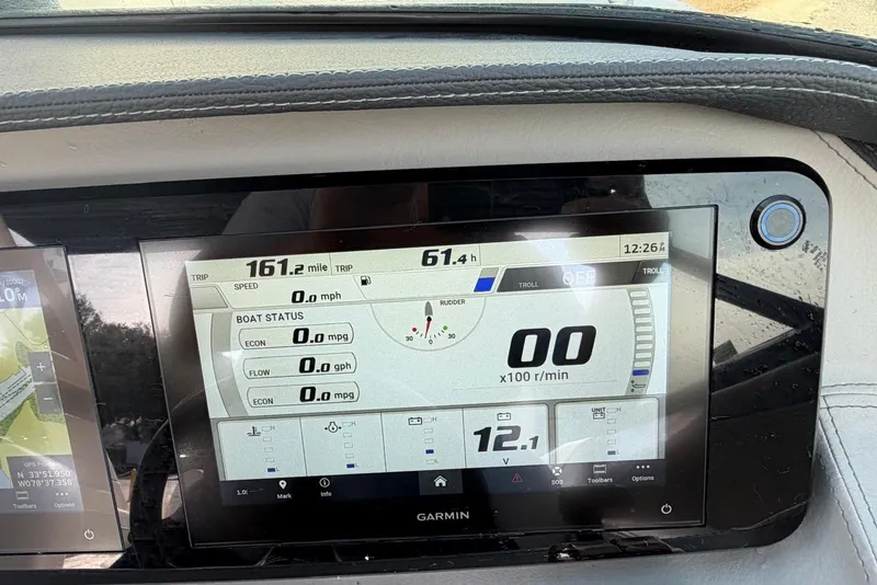 Slide: The Image of 2023 Regal LX4 boat dashboard display showing trip data and boat status. - 21