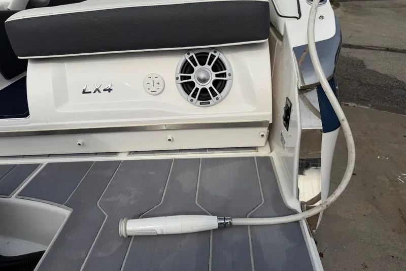 Slide: The Image of 2023 Regal LX4 boat deck with speaker and hose attachment. - 22