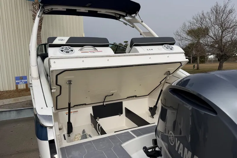 Slide: The Image of 2023 Regal LX4 boat with open storage compartment and Yamaha engine. - 5