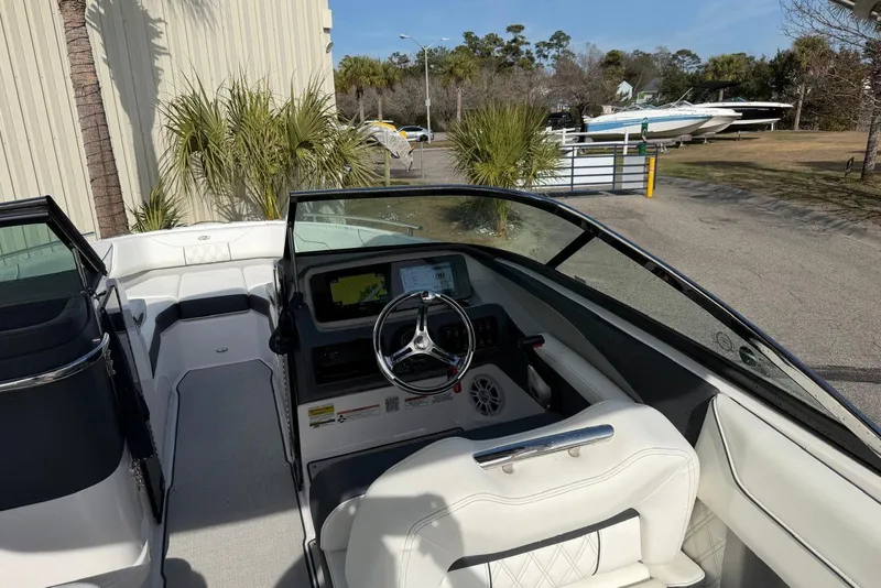 Slide: The Image of 2023 Regal LX4 boat interior with steering wheel and navigation display. - 9