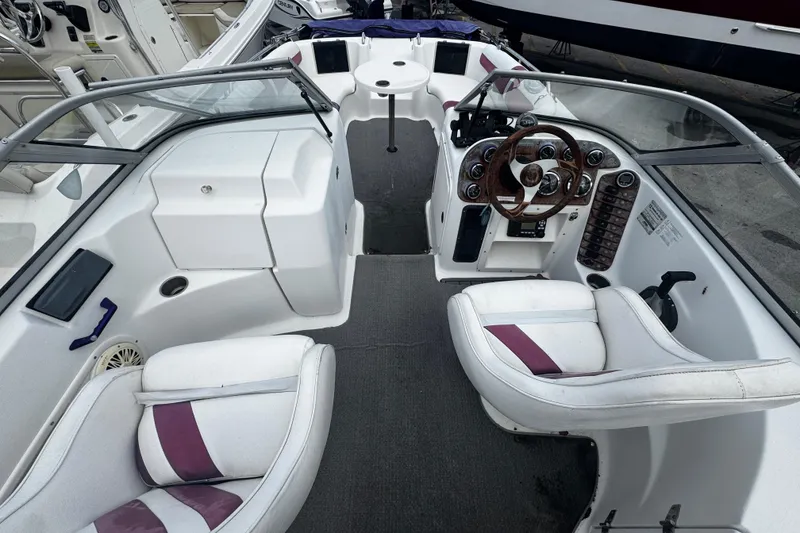 Slide: The Image of 2008 Splendor 240 Sunstar boat interior with steering wheel and seating. - 4