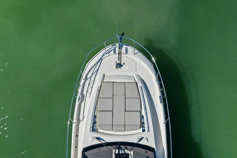 Slide: The Image of Top view of 2022 Prestige 520 yacht on calm green water. - 14