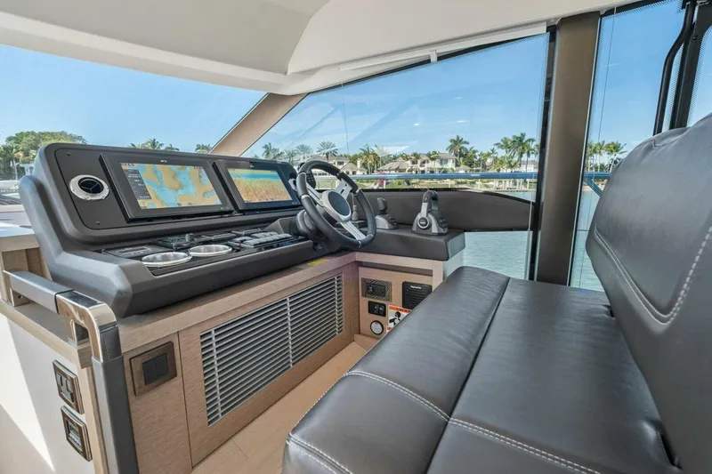 Slide: The Image of Luxurious 2022 Prestige 520 yacht helm with modern navigation displays and leather seating. - 17