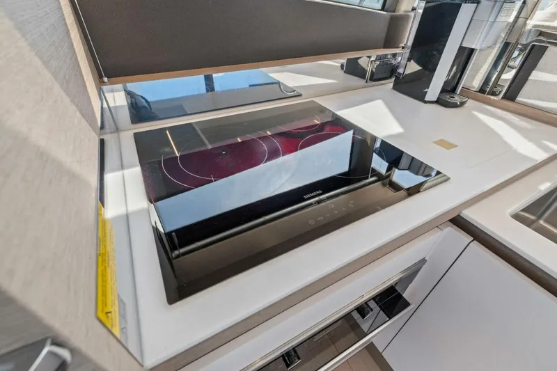 Slide: The Image of Modern kitchen in 2022 Prestige 520 yacht with sleek induction cooktop. - 29
