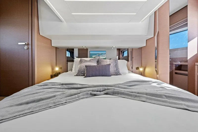 Slide: The Image of Luxurious bedroom interior of 2022 Prestige 520 yacht, featuring elegant bedding and modern design. - 39