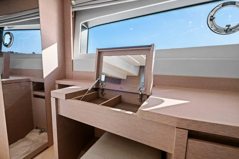 Slide: The Image of Luxurious interior of 2022 Prestige 520 yacht with elegant wooden vanity and window view. - 40