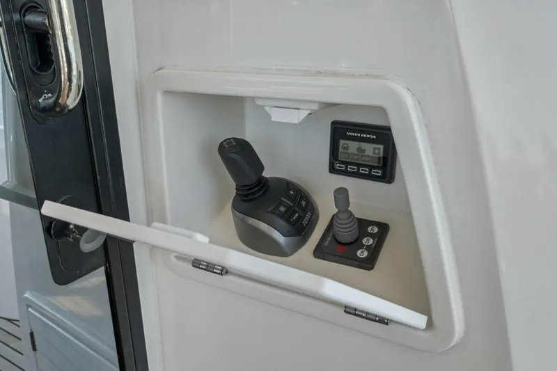Slide: The Image of Control panel of 2022 Prestige 520 yacht featuring joystick and display. - 49