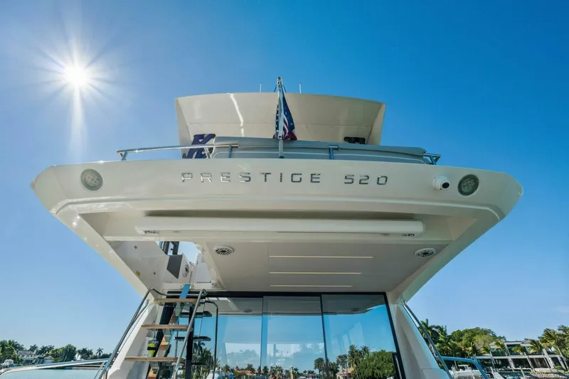 Slide: The Image of 2022 Prestige 520 yacht under bright sun, showcasing sleek design and luxury features. - 50