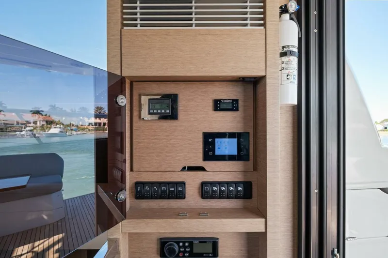 Slide: The Image of Control panel inside 2022 Prestige 520 yacht, featuring modern navigation and safety equipment. - 52