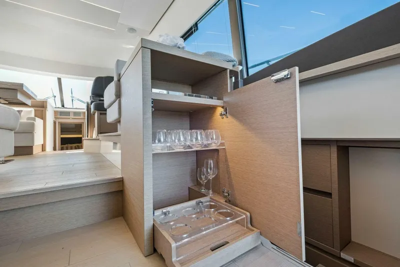 Slide: The Image of Luxurious interior of 2022 Prestige 520 yacht with open cabinet and glassware. - 53