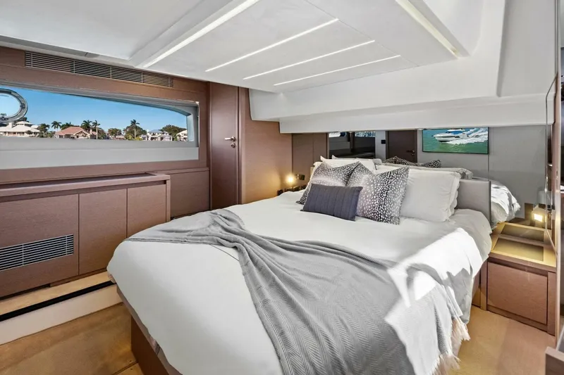 Slide: The Image of Luxurious bedroom interior of 2022 Prestige 520 yacht with elegant decor and scenic window view. - 6