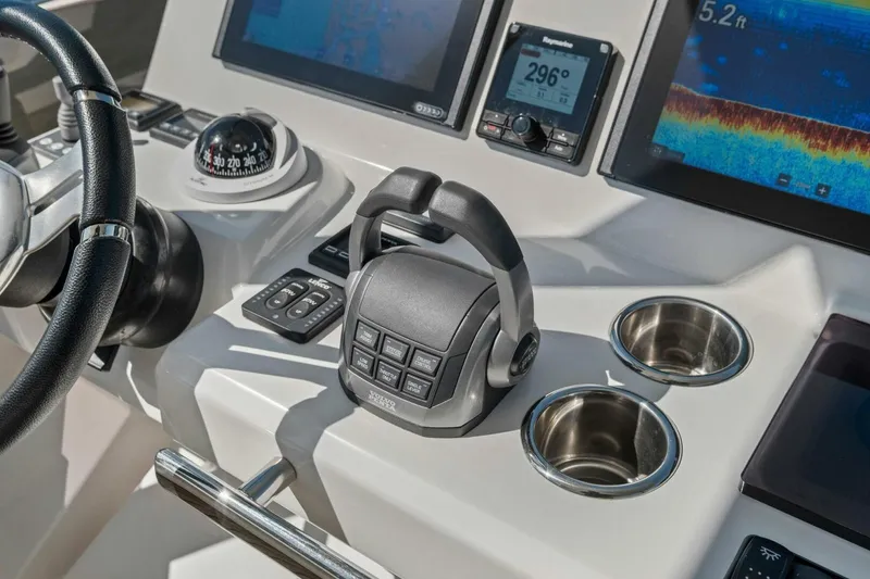 Slide: The Image of Control panel of 2022 Prestige 520 yacht with navigation instruments and cup holders. - 64