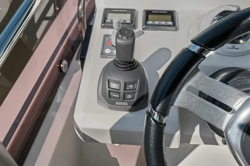 Slide: The Image of Control panel of a 2022 Prestige 520 yacht with joystick and steering wheel. - 66