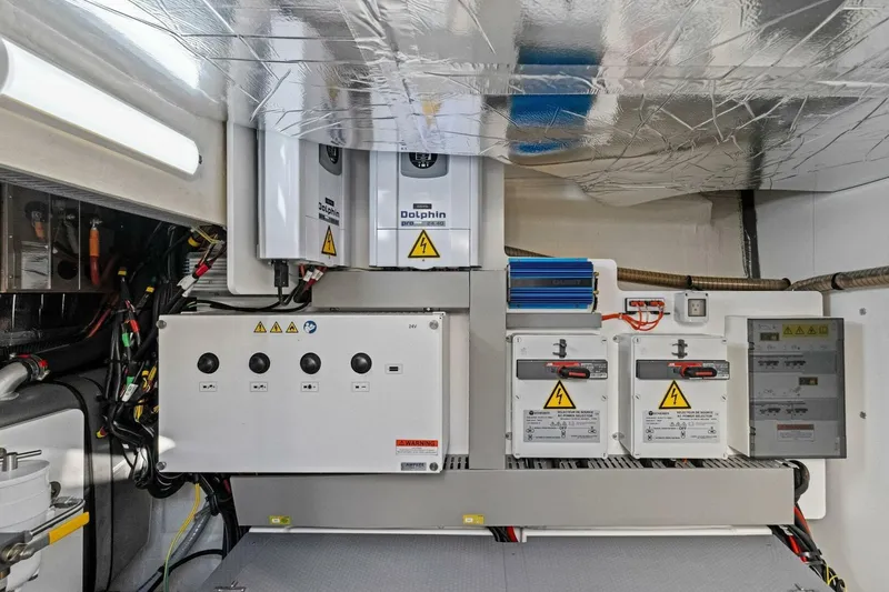 Slide: The Image of Electrical system of a 2022 Prestige 520 yacht, featuring control panels and wiring. - 79