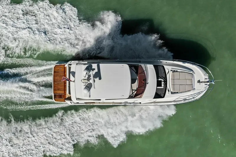 Slide: The Image of Aerial view of 2022 Prestige 520 yacht cruising on green water. - 93