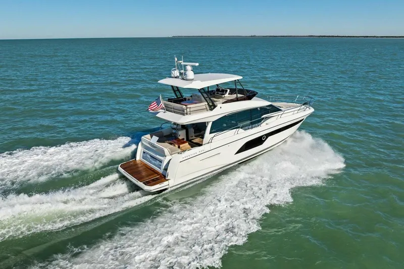 Slide: The Image of 2022 Prestige 520 yacht cruising on open water, displaying sleek design and luxury features. - 94
