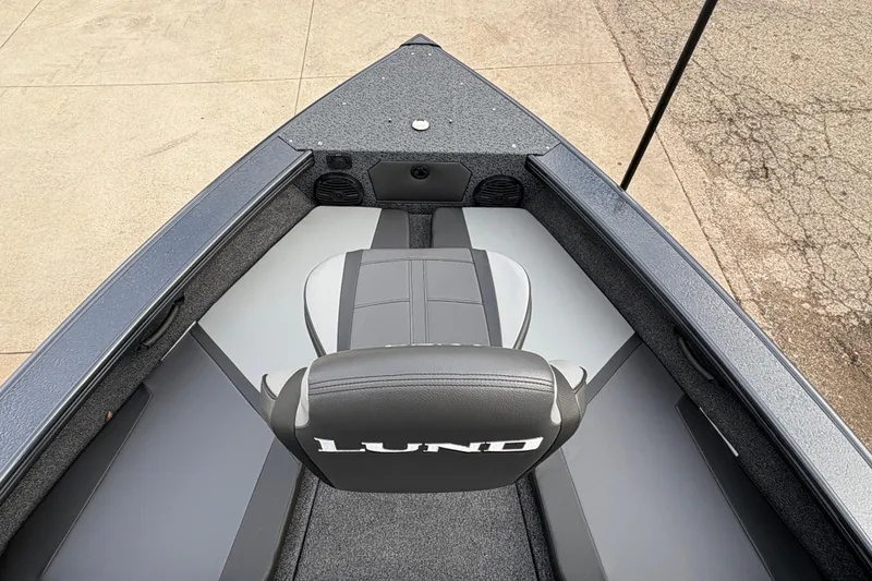 Slide: The Image of 2026 Lund 1875 Crossover XS boat interior with seating and storage compartments. - 10