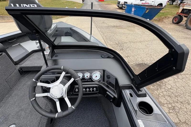Slide: The Image of 2026 Lund 1875 Crossover XS boat dashboard with steering wheel and gauges. - 18