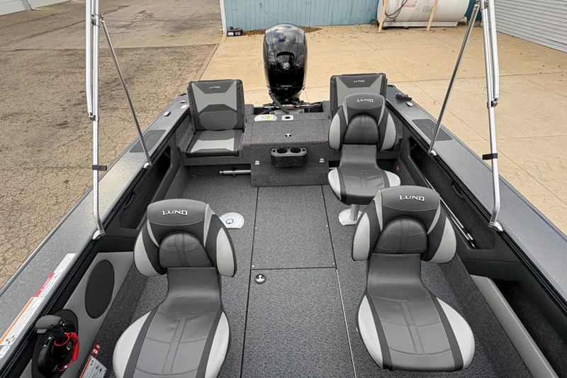 Slide: The Image of 2026 Lund 1875 Crossover XS boat interior with gray seating and modern design. - 21