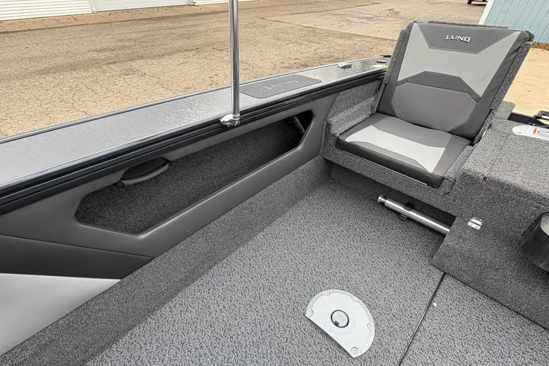 Slide: The Image of Interior of 2026 Lund 1875 Crossover XS boat with gray seating and storage compartments. - 22
