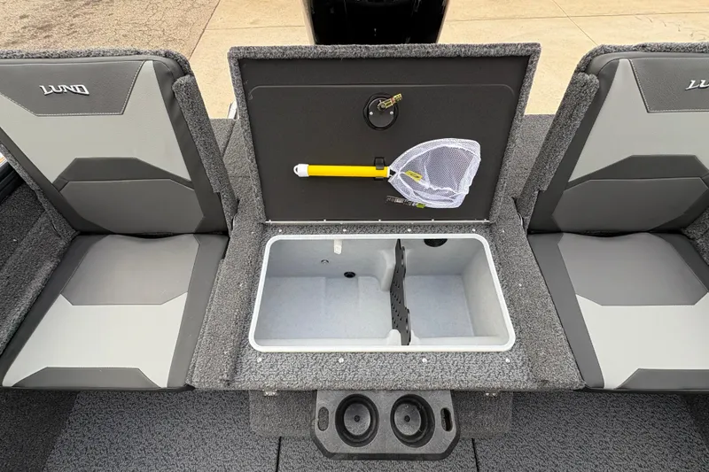 Slide: The Image of 2026 Lund 1875 Crossover XS boat interior with storage compartment and fishing net. - 26