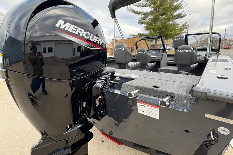 Slide: The Image of 2026 Lund 1875 Crossover XS boat with Mercury engine, featuring spacious seating and modern design. - 3