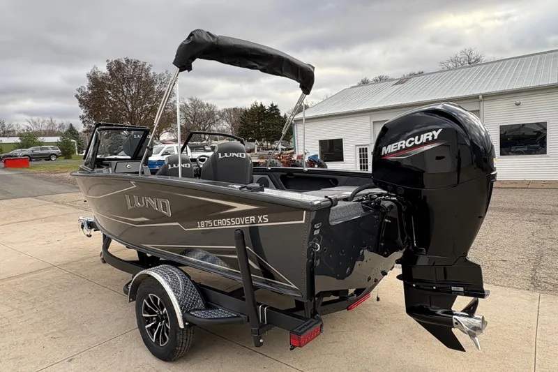 Slide: The Image of 2026 Lund 1875 Crossover XS boat with Mercury engine on a trailer. - 4