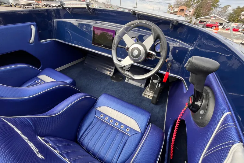 Slide: The Image of 2023 Tuff 20 boat interior with blue seats and modern steering wheel. - 11