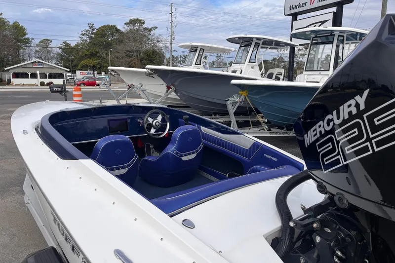 Slide: The Image of 2023 Tuff 20 boat with Mercury 225 engine, blue interior, parked at dealership. - 7