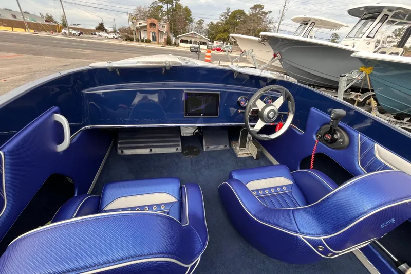 Slide: The Image of 2023 Tuff 20 boat interior with blue seats, steering wheel, and control panel. - 9