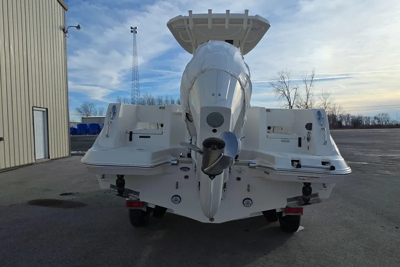 Slide: The Image of 2026 Sailfish 232 CC boat rear view with outboard motor in a parking area. - 4