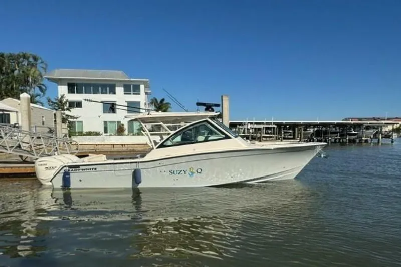 The Image of 2025 Grady-White Freedom 375 boat docked near waterfront homes. - 1